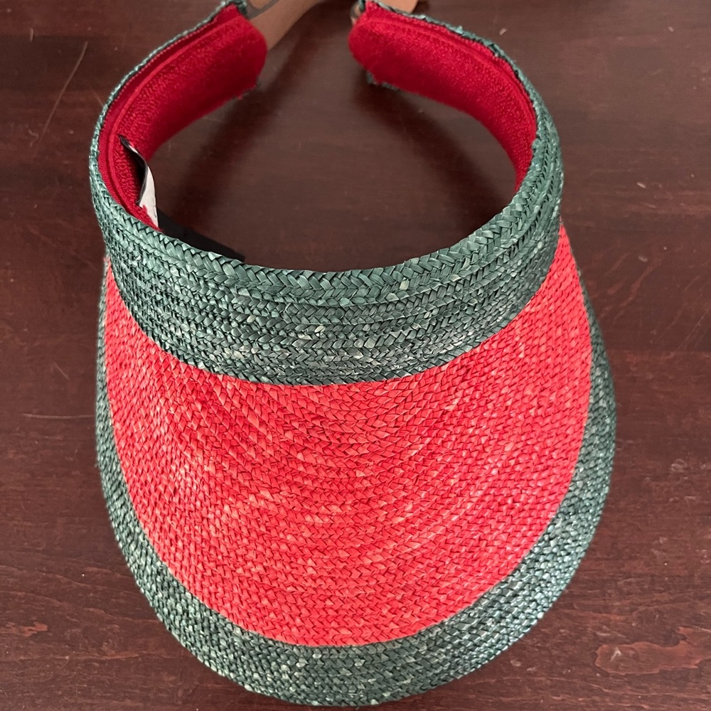 The Gucci Manuel Straw Visor in Green is woven in
Italy
